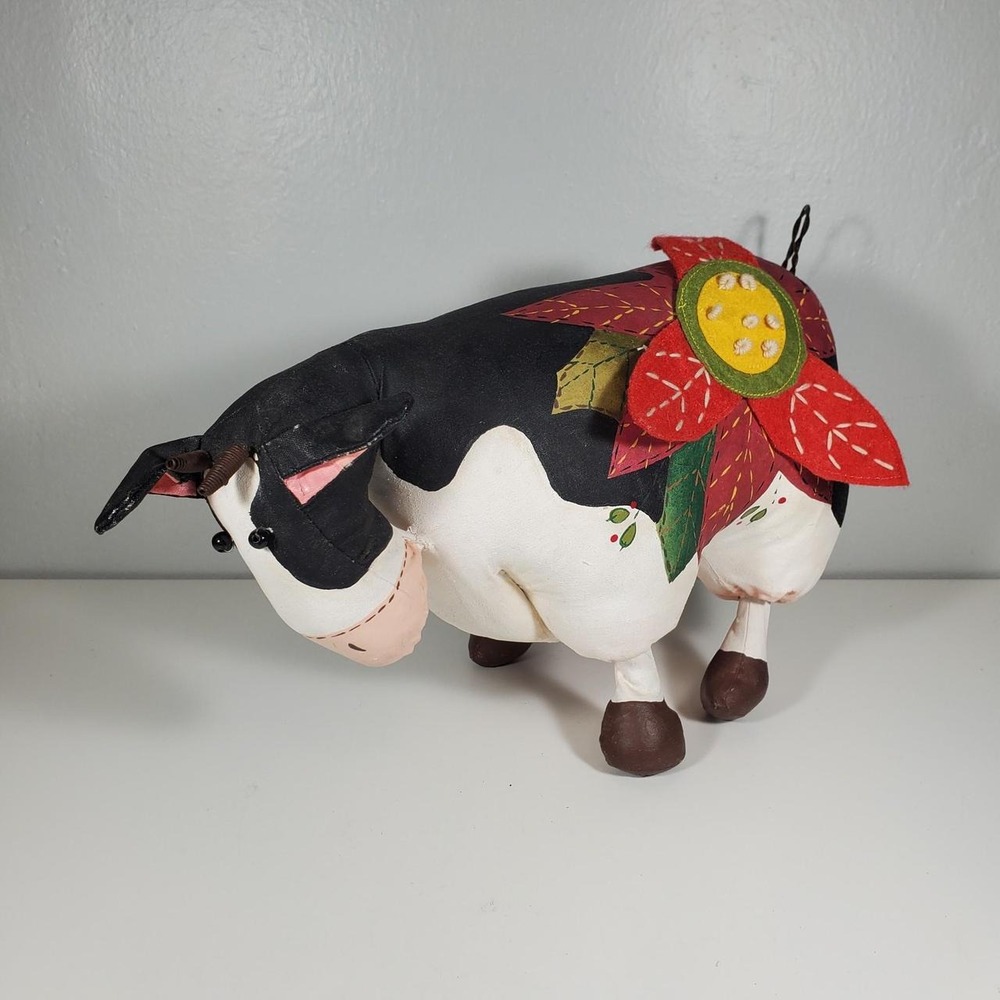 Handmade black & white cow with red poinsettia flower on its back